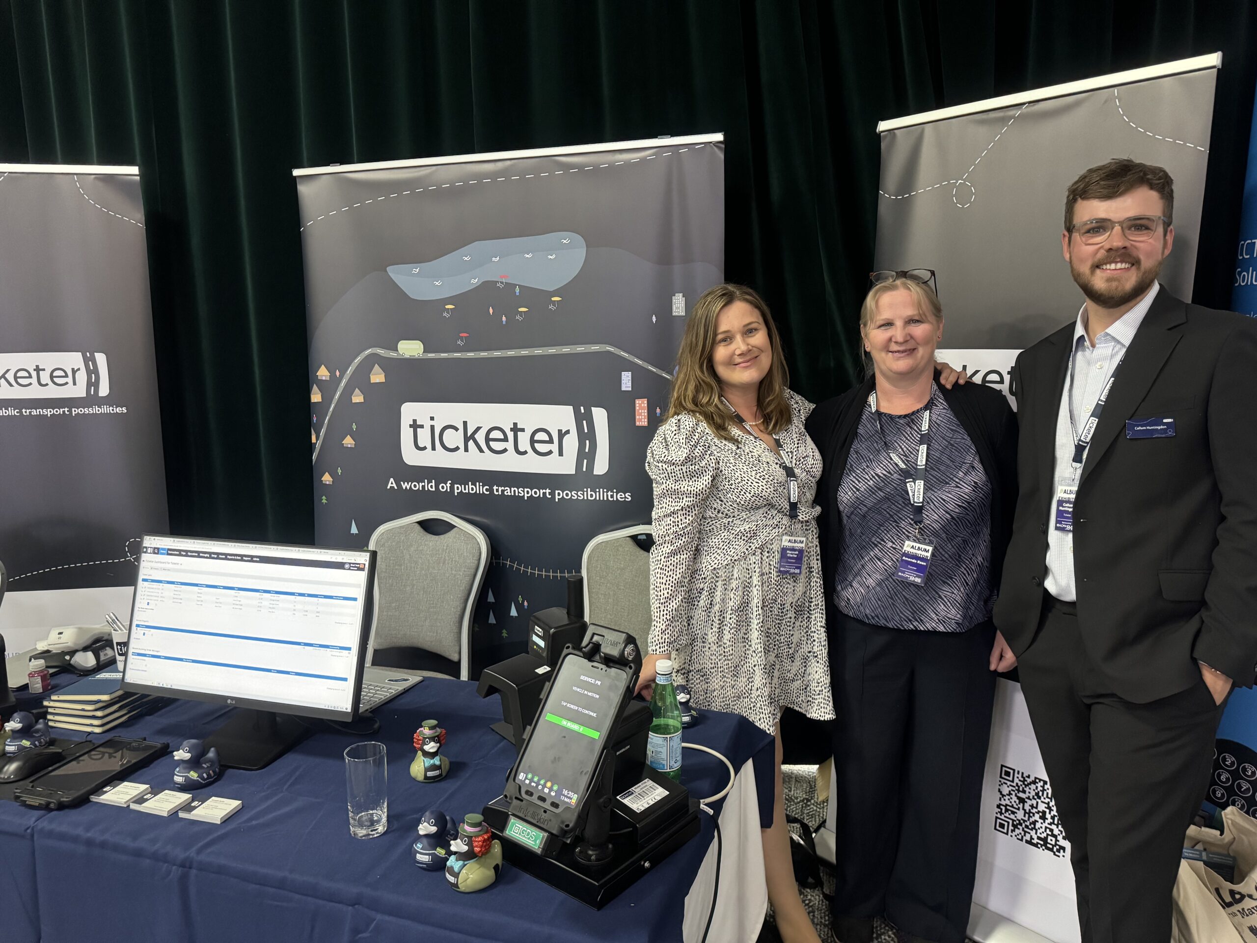 CSDs Hannah, Amanda and Callum in front of Ticketer stand at ALBUM